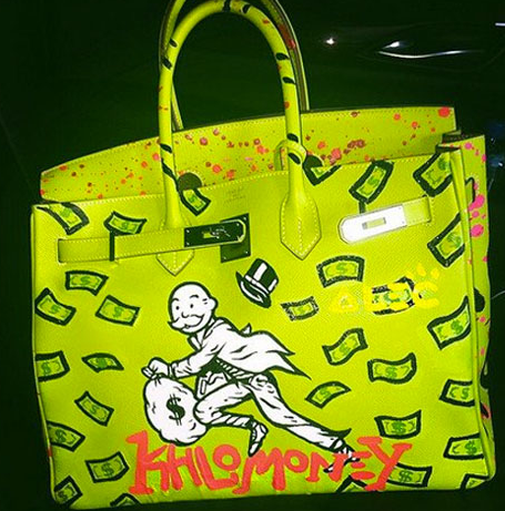 Khloe "Khlomoney" Kardashian had her bag custom painted by graffiti artist Alec Monopoly.