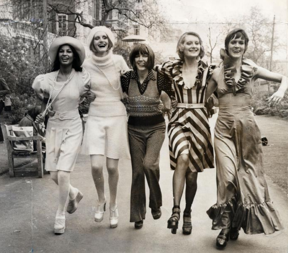 Mary Quant, the face of 1960s London fashion, stands in Embankment Gardens with models wearing her Autumn/Winter 1972 collection. Known for her youthful, rebellious designs and her King’s Road boutique Bazaar, Quant revolutionized how a generation dressed — creating fashion for the young, not just about them."