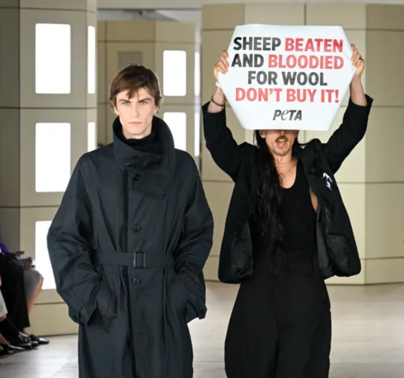 PETA activists interrupt the COS Spring/Summer 2027 show midway, protesting H&M Group’s use of wool. 
