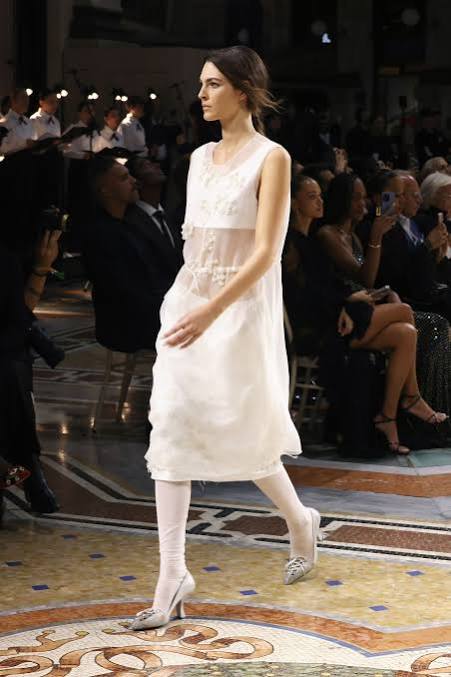 Vittoria Ceretti closes the evening in a custom Prada Memory Dress of three layered tiers of sheer white organza and gazar, designed by Miuccia Prada and Raf Simons
